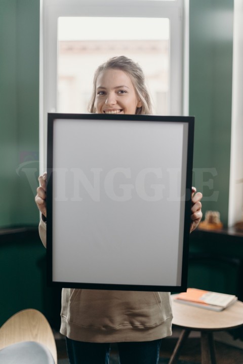 Woman Holding Black Wall Frame Mockup